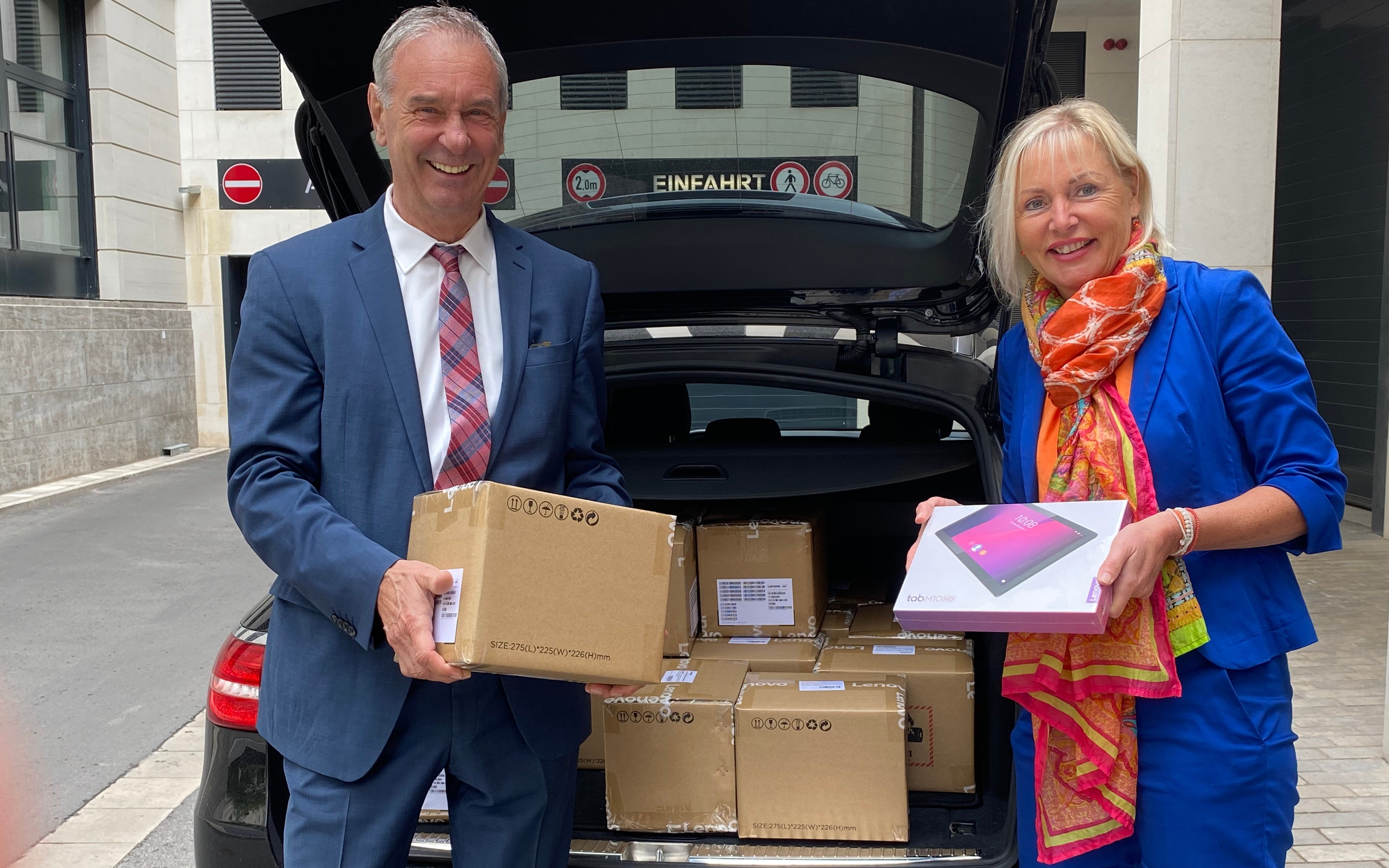 Kristina Sinemus und Ulrich Künkel bei der Entgegennahme von einer großen Menge Tablets.