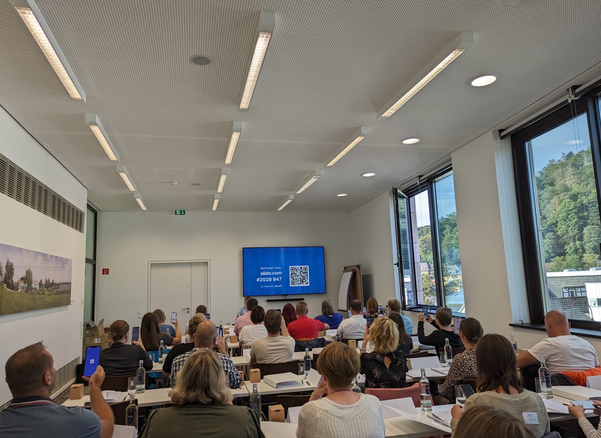 Teilnehmende während einer Präsentation des Umfrageprogramms Slido.