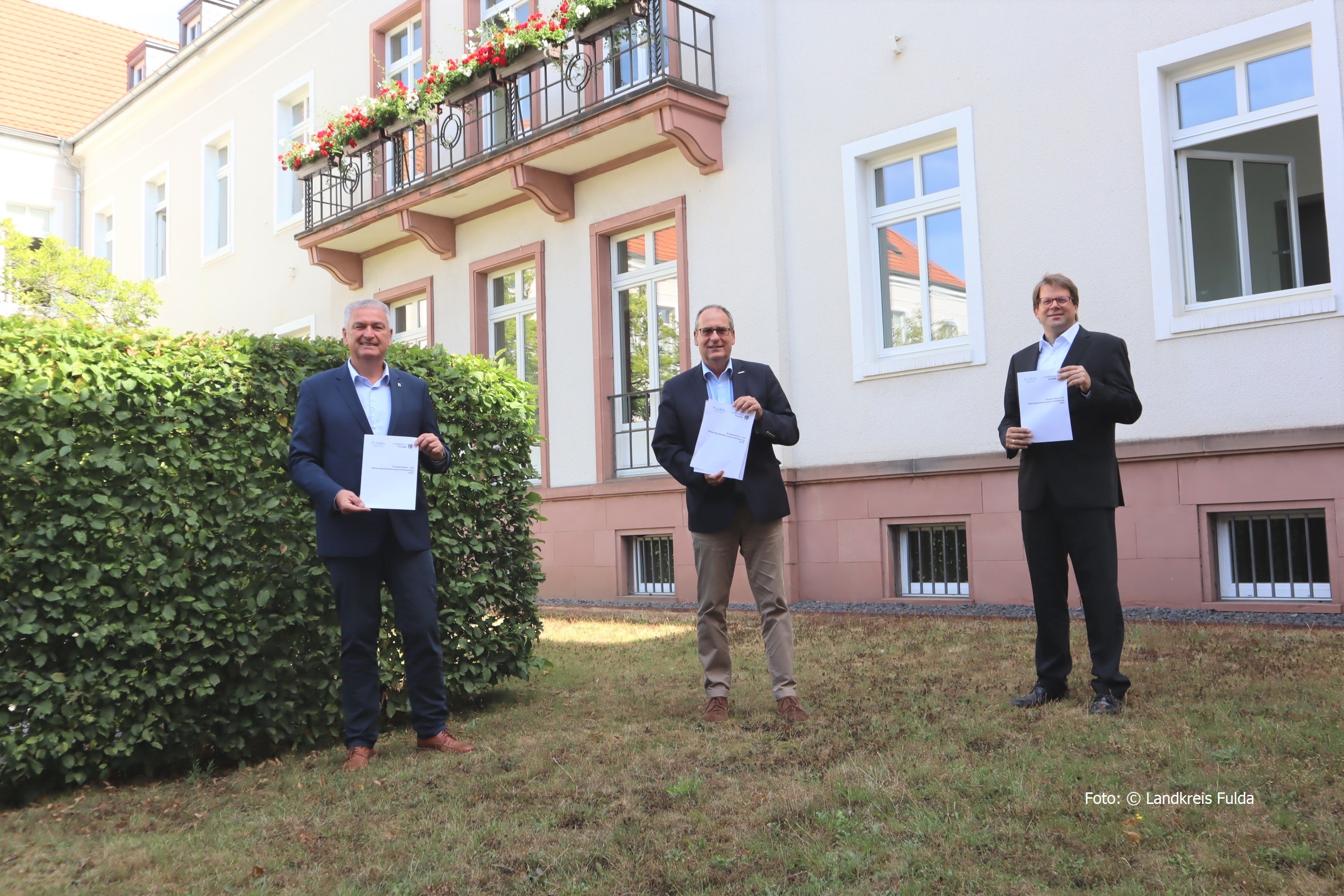 Bernd Woide; Bertram Huke und Heiko Wingenfeld vor der Aussenfassade eines Gebäudes.