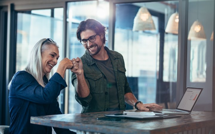 Business colleagues making a fist bump at office