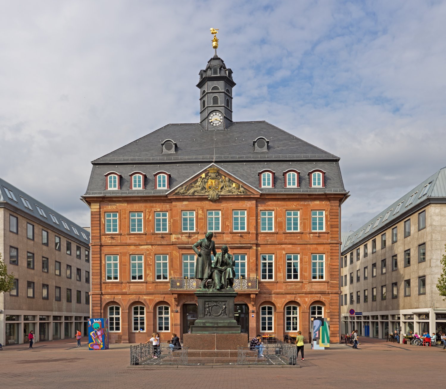 Das Neustädter Rathaus mit dem Brüder-Grimm-Denkmal (© Jörg Braukmann, Wikimedia)